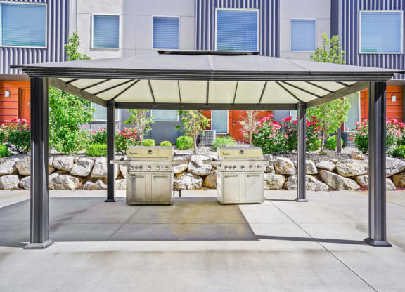 a covered barbecue area with two bbq grills  at Aero Luxury Townhomes in Layton, Utah
