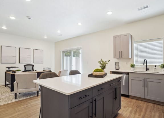an open kitchen and living room with a table and chairs