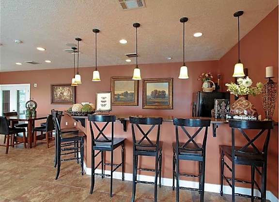 A dining room with a table and chairs.