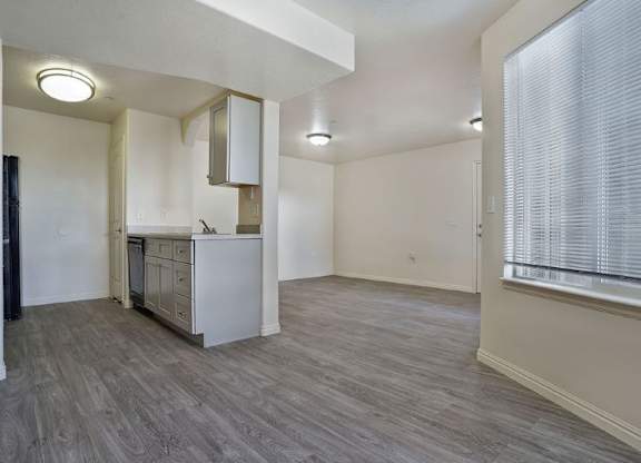 A kitchen area with a refrigerator, microwave, and oven.
