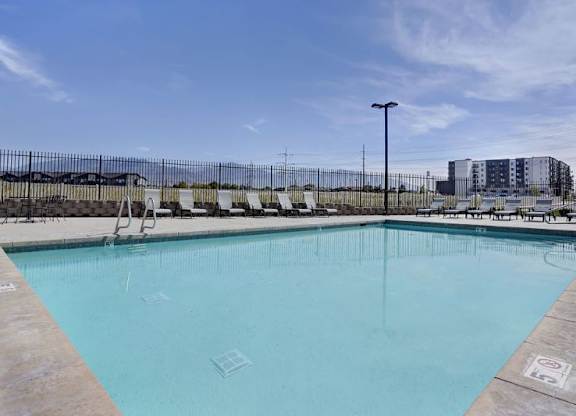 A large swimming pool with a blue tinted water.