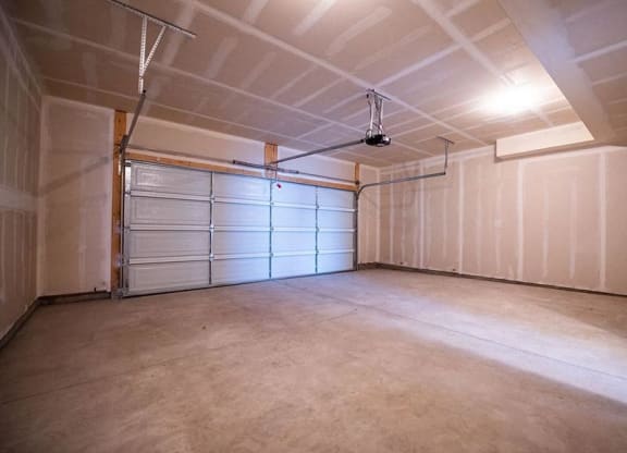a garage with a white wall and a garage door