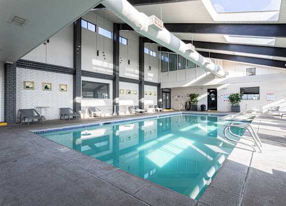 A large indoor swimming pool with a skylight above it.