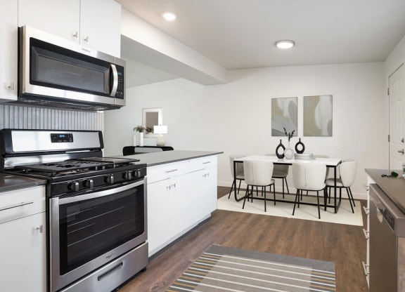 an open kitchen and dining room with a table and chairs