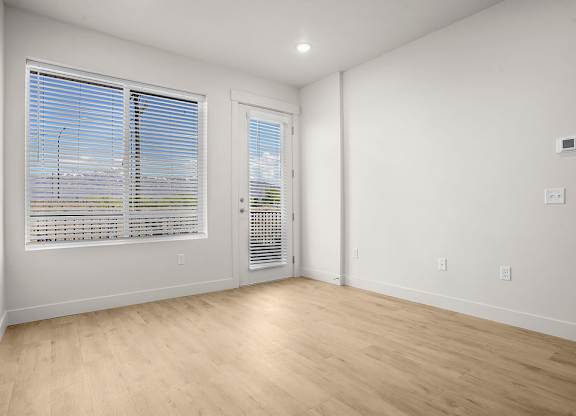 A room with a window and a door.