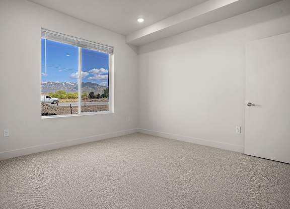 A room with a large window overlooking a landscape.