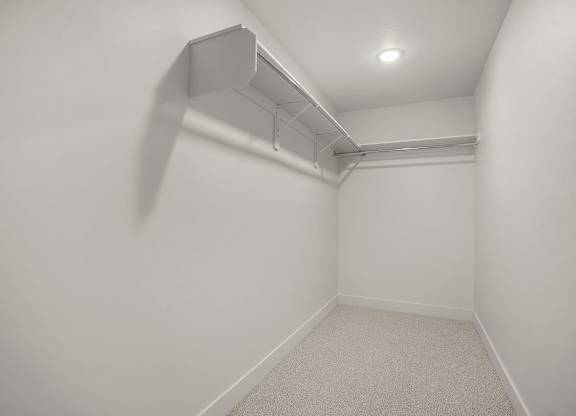 A white room with a light on the ceiling and a vent on the wall.