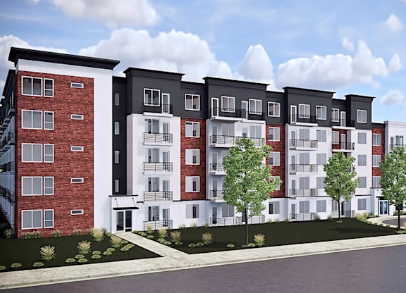 A modern apartment complex with red brick and white buildings.