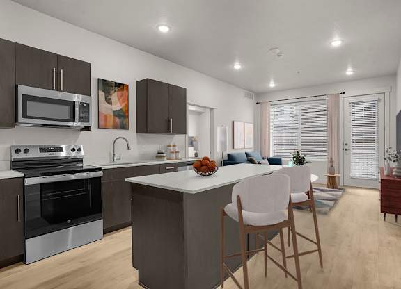 A modern kitchen with a large island and wooden chairs.