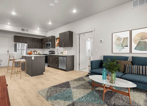 A modern kitchen with a dining table and a couch.