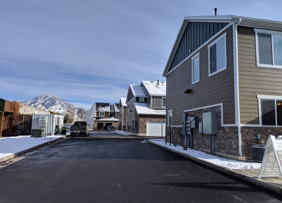 a street with houses and a mountain in the background