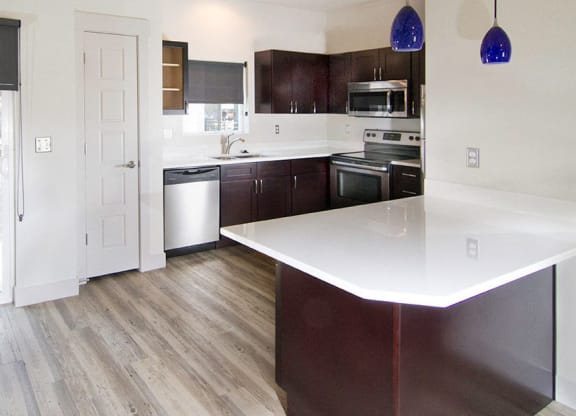 an empty kitchen with a door to a balcony at BlueKoi Townhomes for rent in Salt Lake City, UT