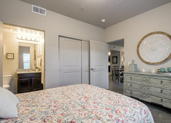 a bedroom with a bed and a dresser