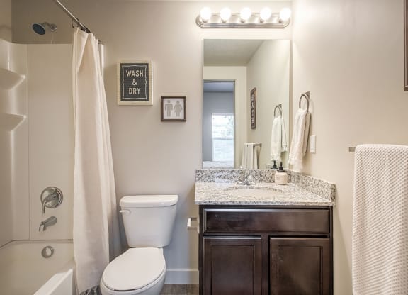 a bathroom with a toilet sink and shower