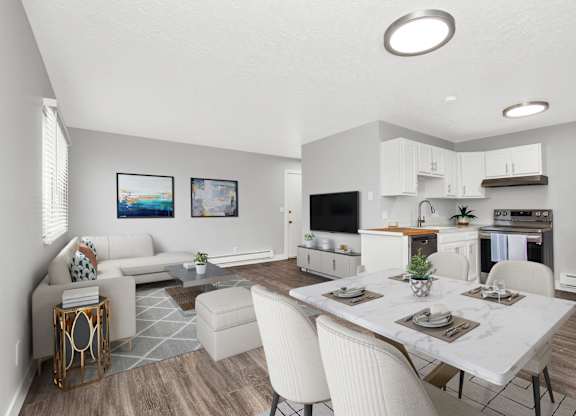 A modern kitchen with a dining table set for four.