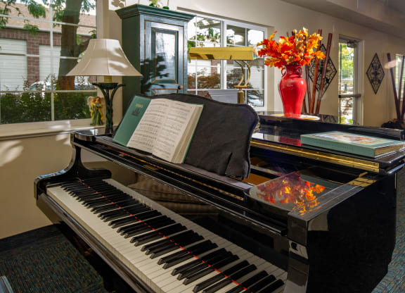 a piano with a book on it in a lobby