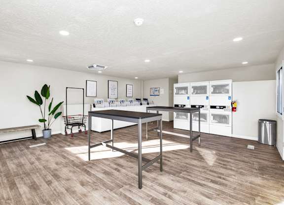 A kitchen with a table and chairs in the middle of the room.