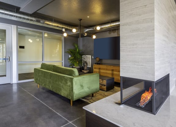 a living room with a fireplace and a green couch