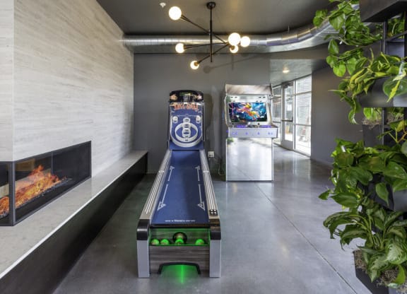 a room with a video game and a gas fireplace