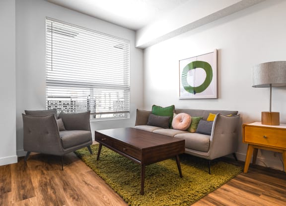 a living room with a couch and two chairs at Lotus Gallacher luxury apartments for rent in Salt Lake City, UT