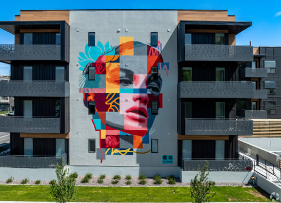 a mural of a face on the side of a building at Lotus Gallacher luxury apartments for rent in Salt Lake City, UT