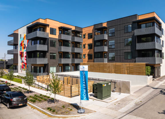 an apartment building with a sign in front of it at Lotus Gallacher luxury apartments for rent in Salt Lake City, UT