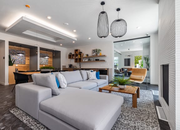 a living room with a white couch and a table at Lotus Gallacher luxury apartments for rent in Salt Lake City, UT