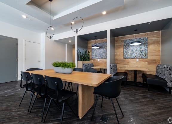 a dining room with a wooden table and chairs at Lotus Gallacher luxury apartments for rent in Salt Lake City, UT