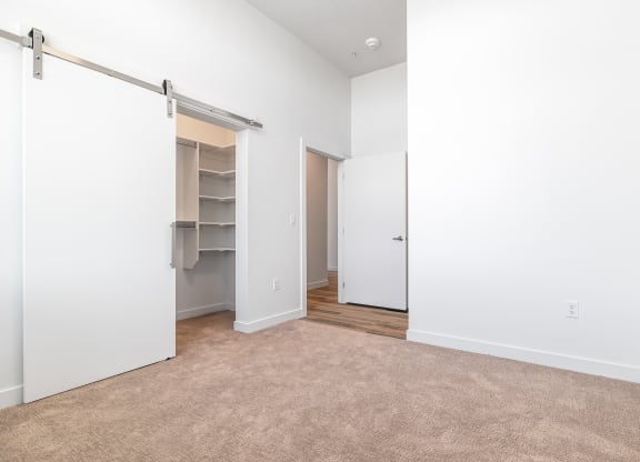 an empty room with a closet and a carpeted floor at Lotus Gallacher luxury apartments for rent in Salt Lake City, UT
