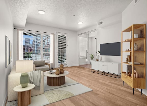 A modern living room with a flat screen TV and a view of the city.