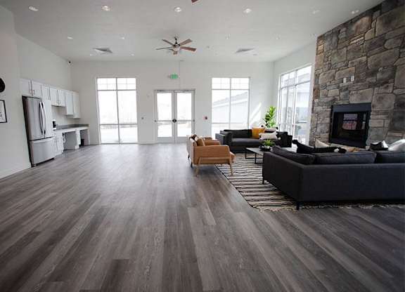 A living room with a stone wall and a fireplace.