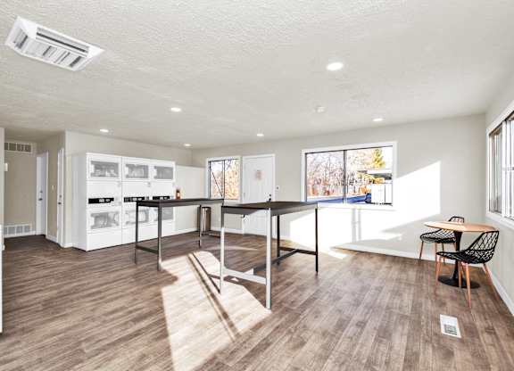 A kitchen with a table and chairs in the middle of the room.