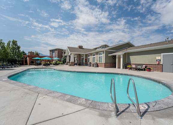 A swimming pool in front of a house.