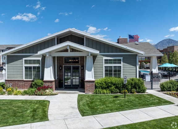 clubhouse building entrance with green grass at Outlook Apartments for rent in Springville and Provo, UT.