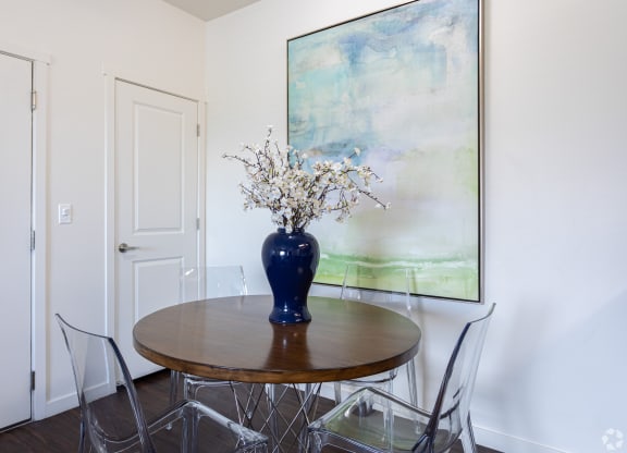 a dining room with a table and art at Outlook Apartments for rent in Springville and Provo, UT.