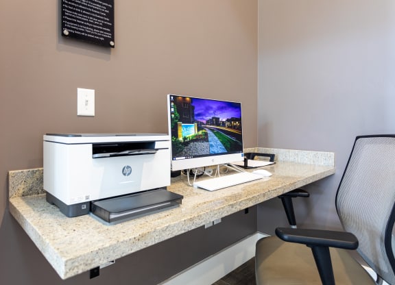 an office with a computer and printer on a desk in an office area at Outlook Apartments for rent in Springville and Provo, UT.