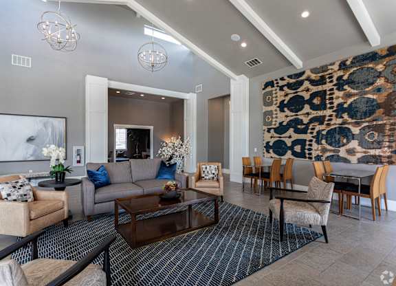 A living room with a leopard print wallpaper and a grey sofa.