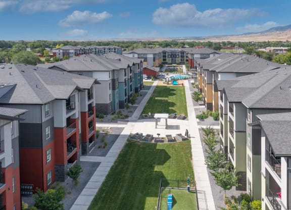 an aerial view of a yard in front of an apartment complex