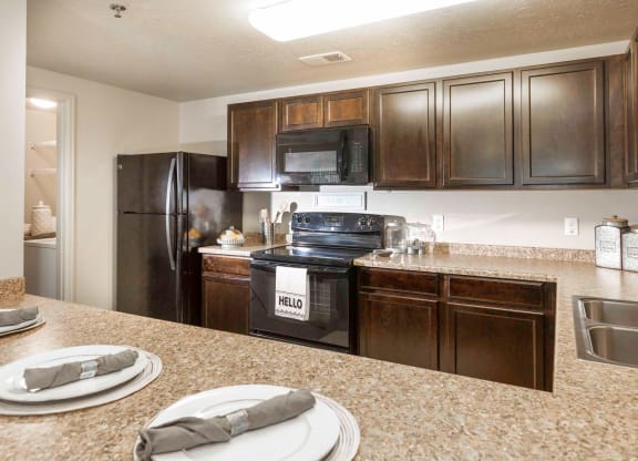 a kitchen with wooden cabinets and black appliances