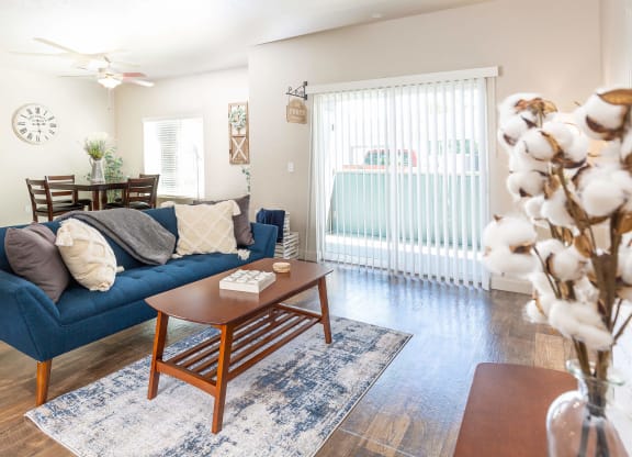 a living room with a blue couch and a wooden coffee table