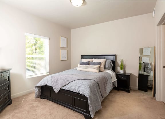 a bedroom with a large bed and two night stands