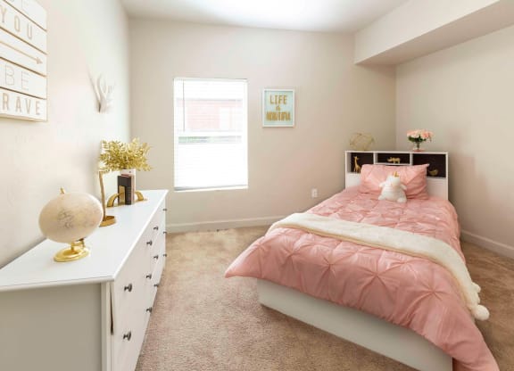 a bedroom with a bed and dresser