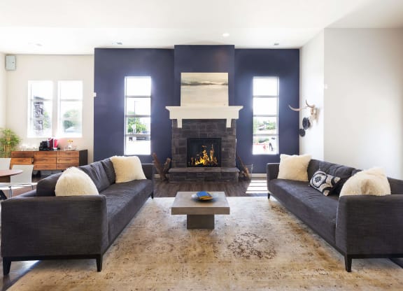 a living room with a fireplace and two couches
