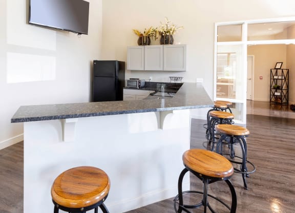 a kitchen with a counter top and stools