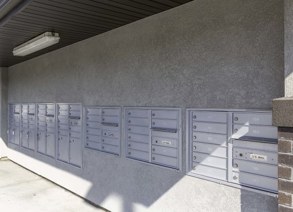 a picture of the side of a building with a bunch of mailboxes