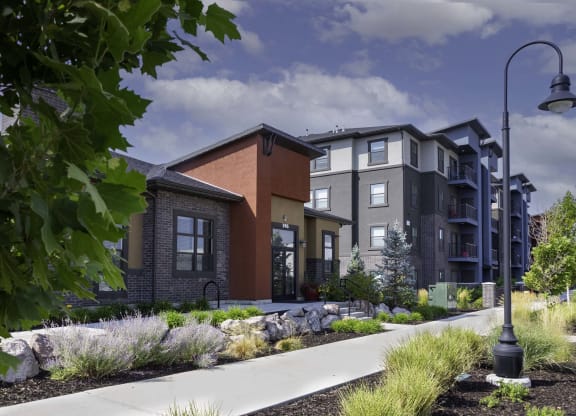 a rendering of an apartment building with a sidewalk in front of it