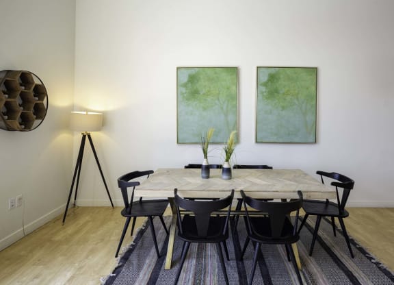 a dining room with two paintings on the wall