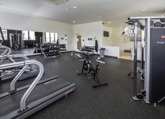 a room filled with lots of different types of exercise equipment