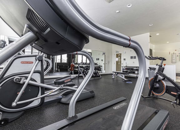 a room filled with lots of different types of exercise equipment