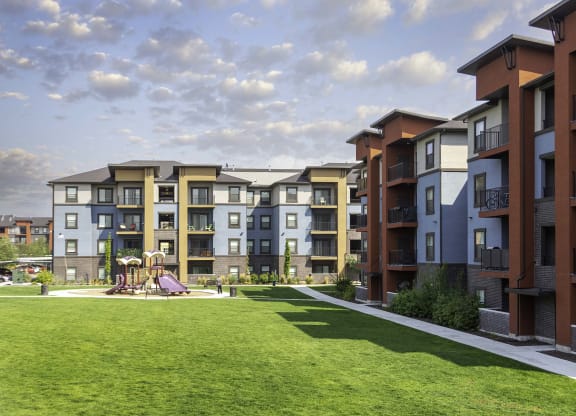 an exterior view of an apartment complex with a playground